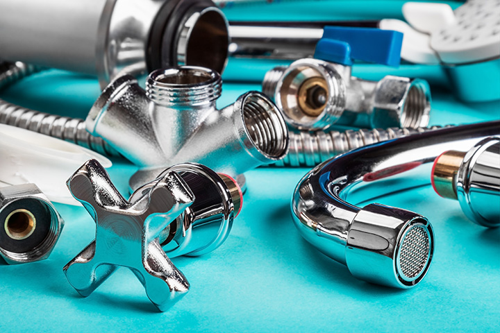 Chrome plumbing parts agains a turquoise background